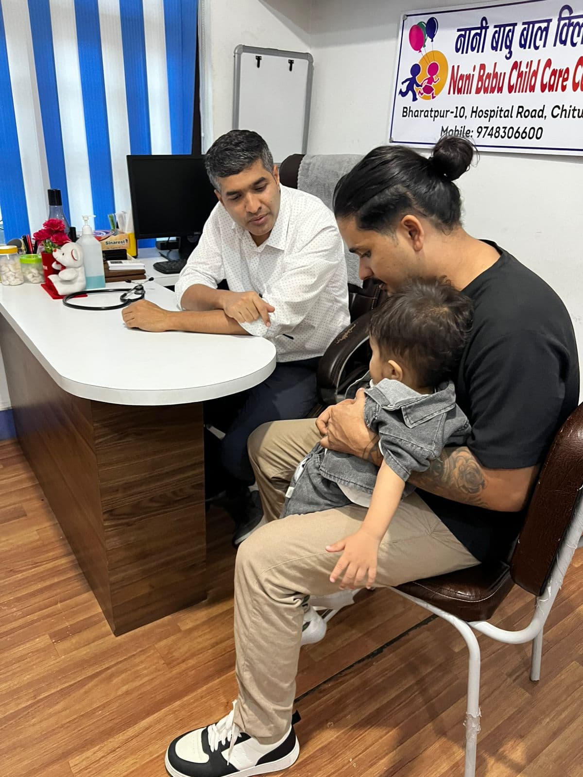 Dr. Yograj Sharma counselling a parent during a child health consultation